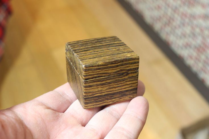 a small wooden object in someone's hand