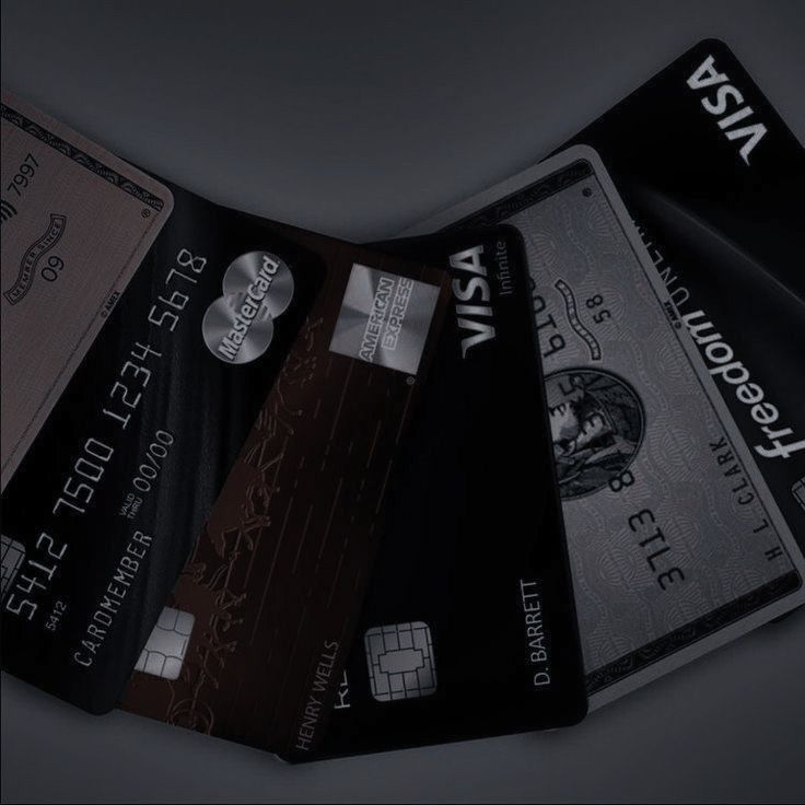 four credit cards stacked on top of each other