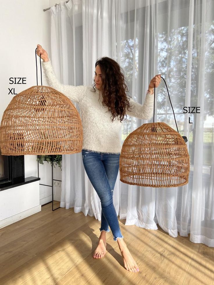 a woman holding two wicker baskets in her hands