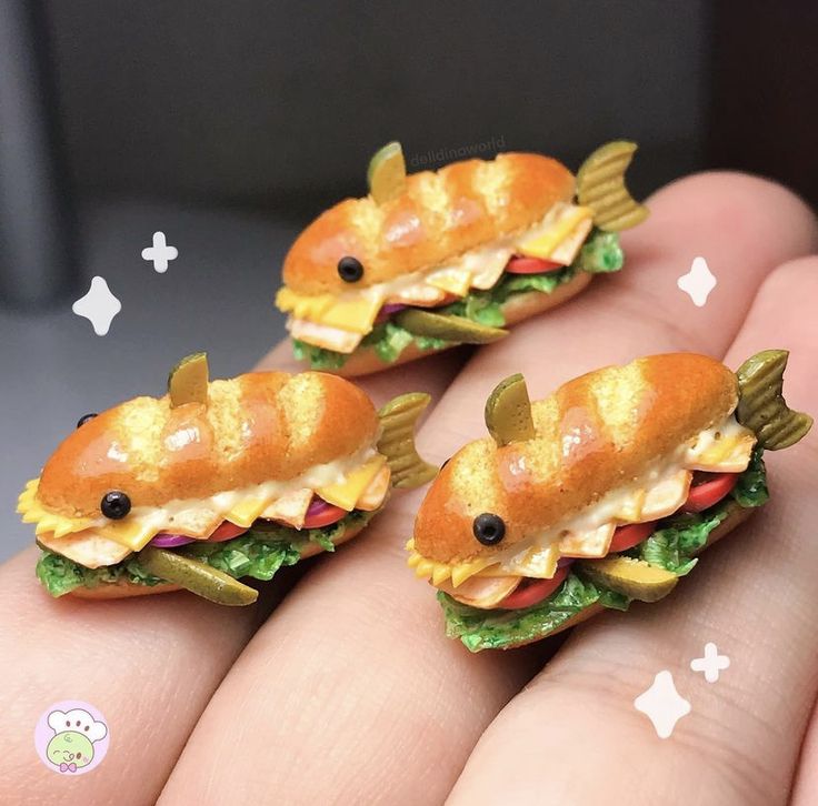 three tiny toy sandwiches with fish on them