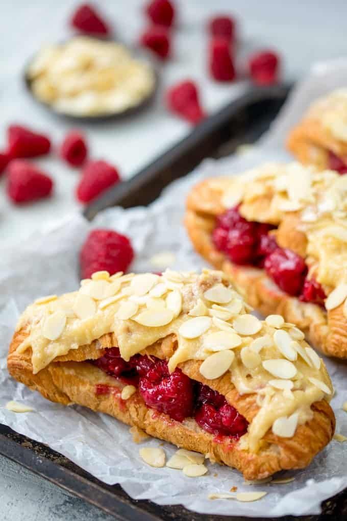 raspberry and almond pastries on parchment paper