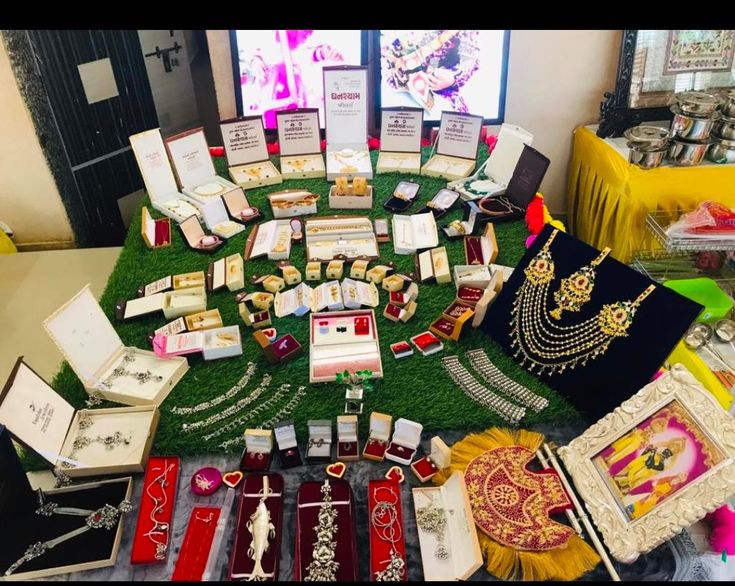 a table topped with lots of different types of jewelry and framed pictures on top of it