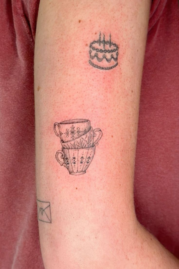 a woman with a tattoo on her arm has a cupcake and a cake in it