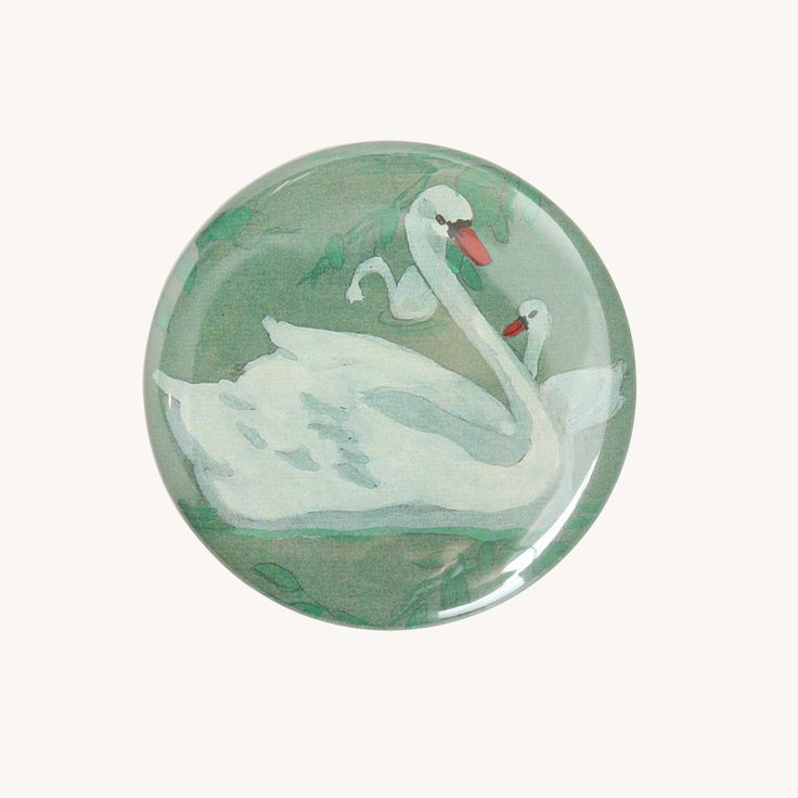 a glass plate with a white swan on it