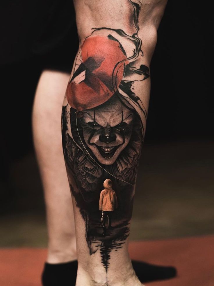 a man's leg with a clown tattoo on it