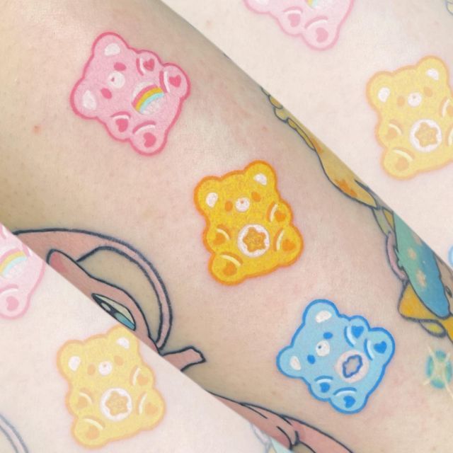 the legs are decorated with colorful bears and rainbows on their skin, as if they were tattoos