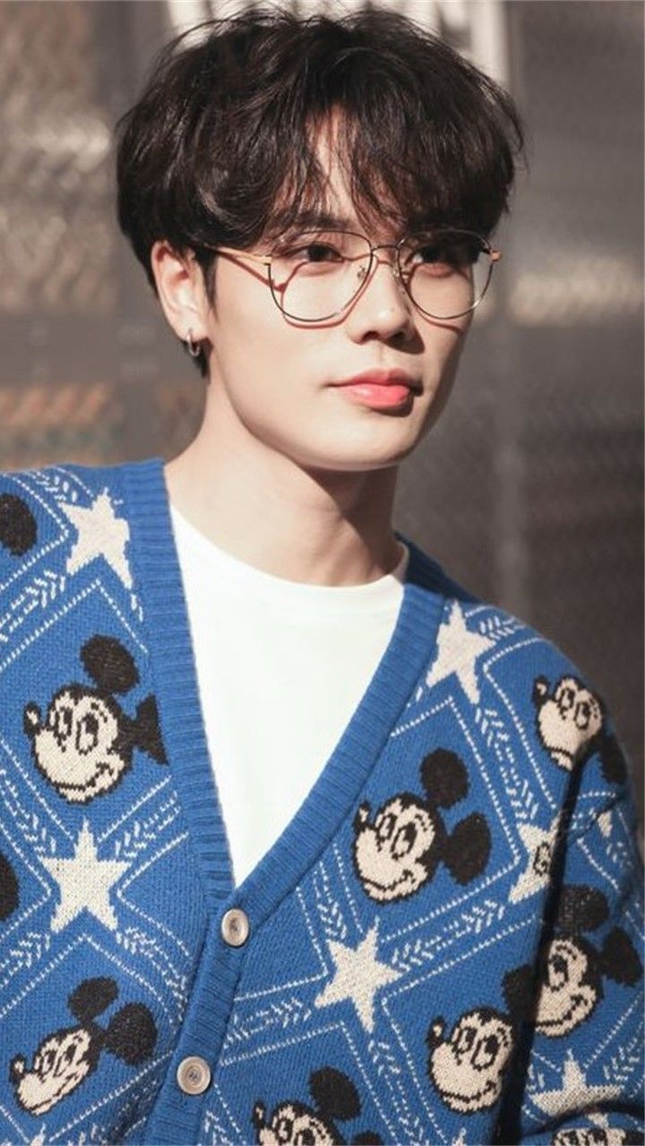 a person wearing glasses and a mickey mouse sweater