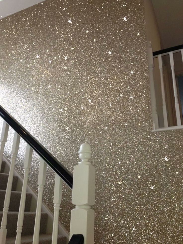 stairs with glitter paint on the wall and white handrails in front of them