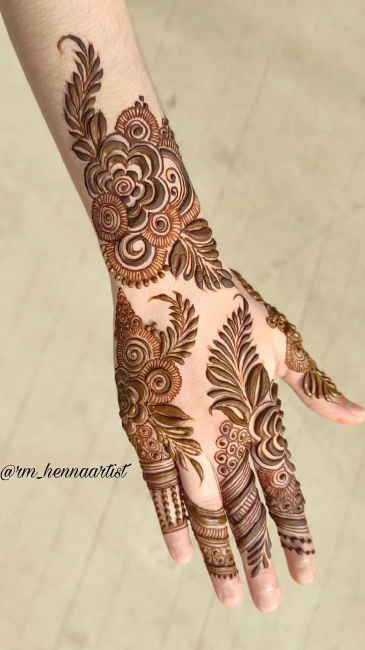 the hand is decorated with henna designs