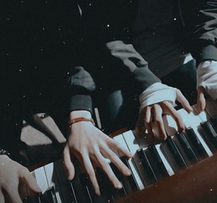 two hands are playing the piano together