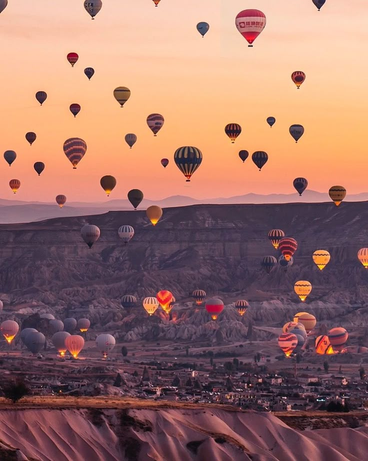 many hot air balloons are flying in the sky