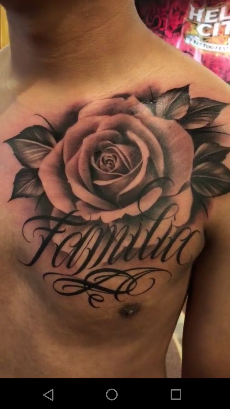 a man's chest with a rose tattoo on it and the words family written in cursive font