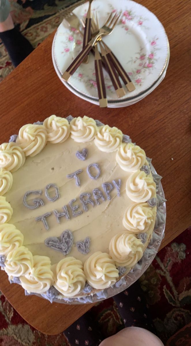 a birthday cake with the words go to therapy written on it sitting on a table