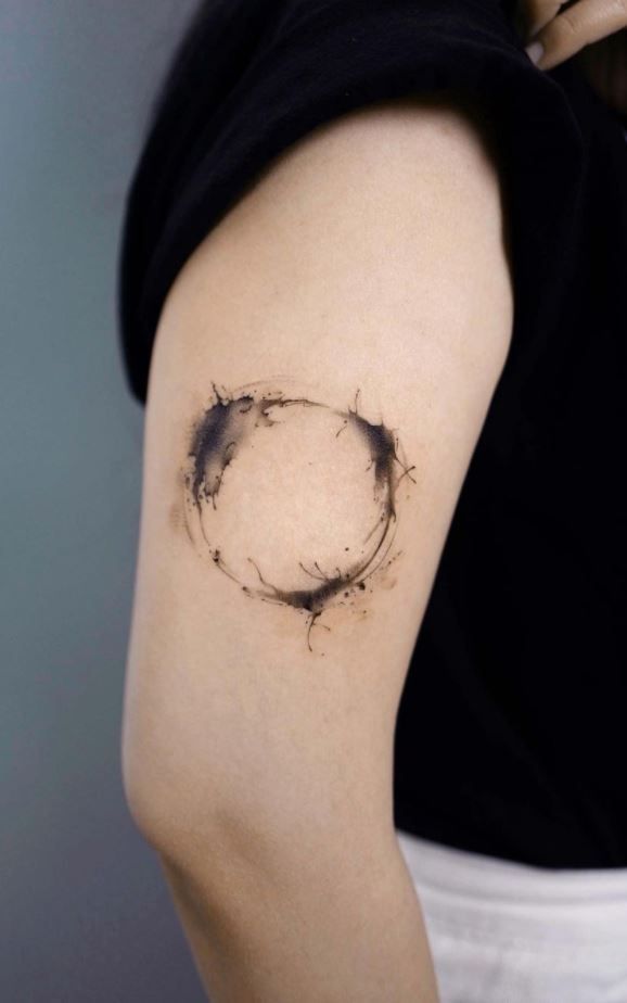 a woman with a circle tattoo on her arm