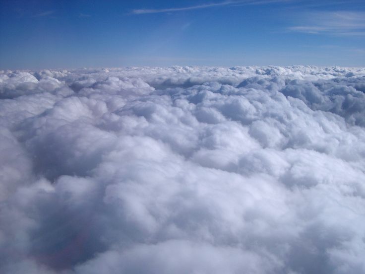 a ship floating above the clouds in the sky