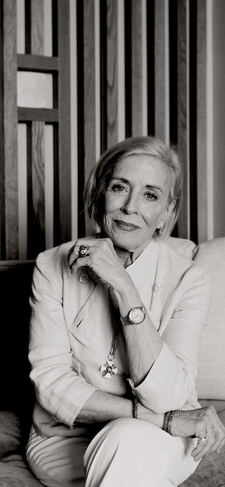 an older woman sitting on top of a couch