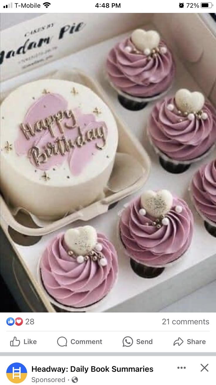 a box filled with lots of cupcakes covered in pink frosted icing