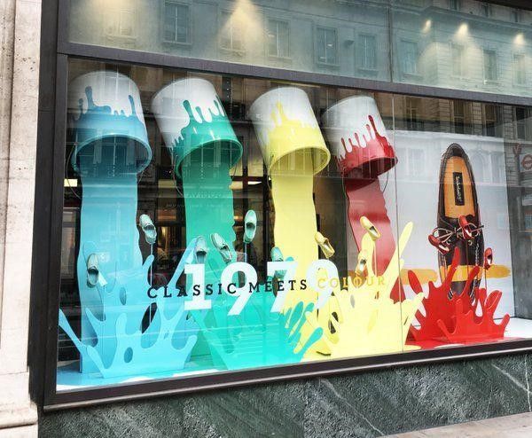 there are many different colored fire hydrants in this store window glass display, with the words classic street written on it