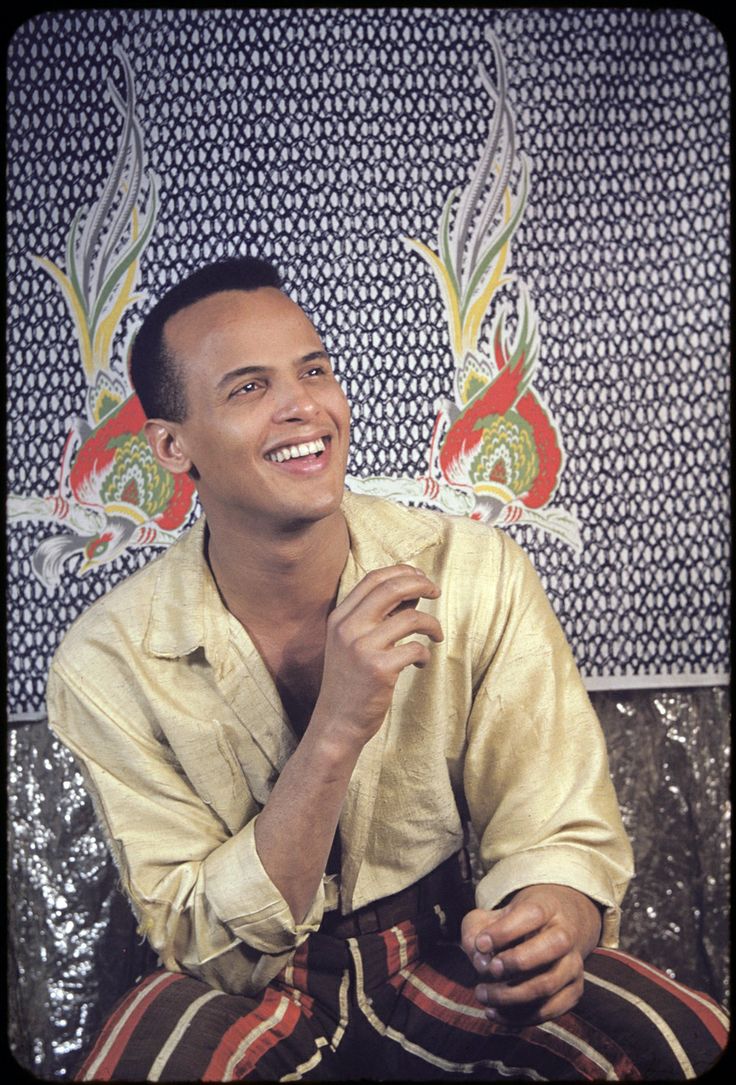 a man sitting on top of a couch smiling