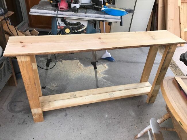 a workbench made out of wood in a garage with tools on the table