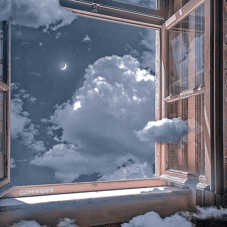 an open window looking at the sky and clouds