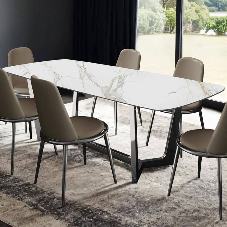 a dining table with chairs around it in front of a large window and an area rug