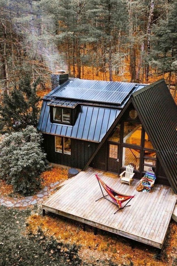 a small cabin in the woods with a hammock