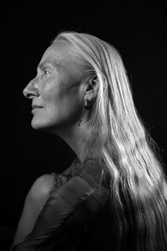 a black and white photo of a woman with long hair looking off to the side