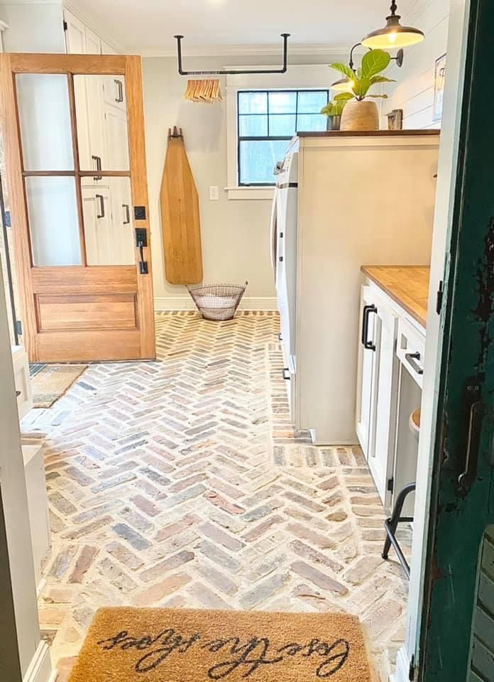 an open door leading to a kitchen with a happy new year mat on the floor