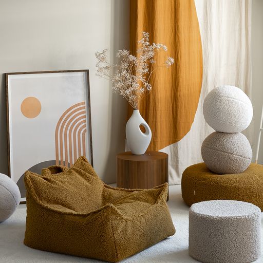 a living room filled with different types of furniture and decor on top of carpeted flooring