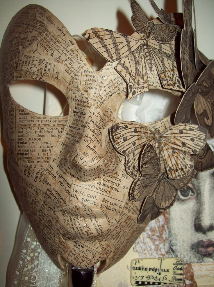 a mask made out of newspaper with butterflies on it