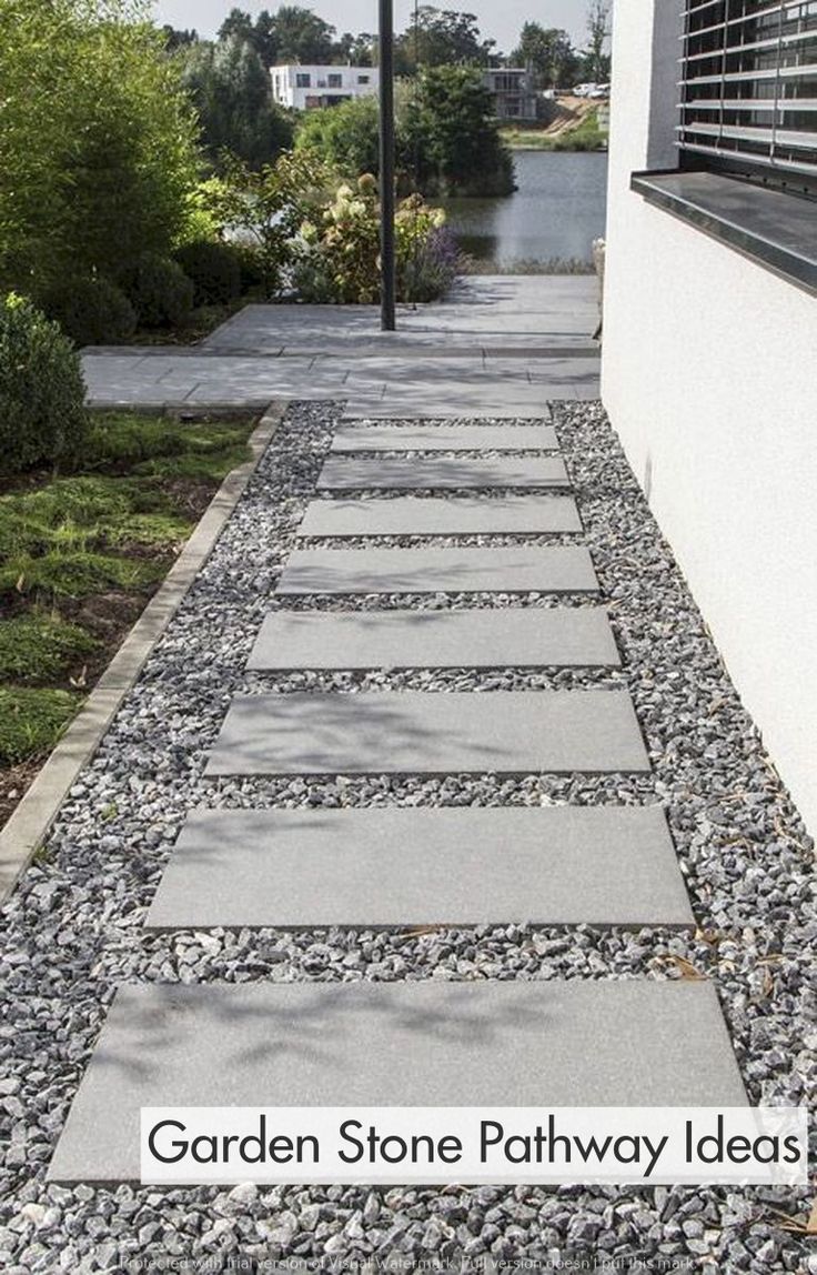 a stone pathway leads up to the side of a house