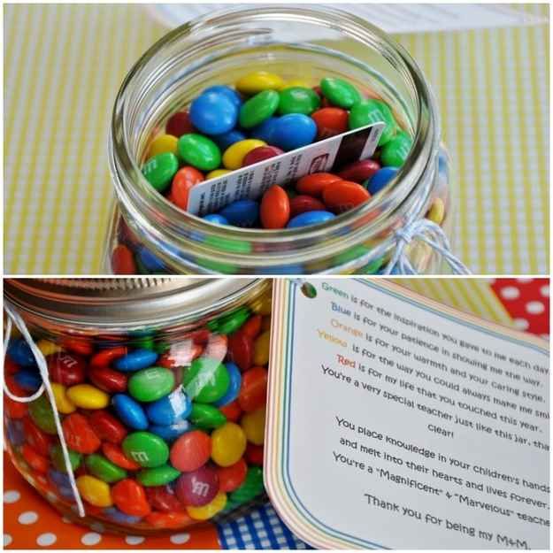 a jar filled with candy sitting on top of a table next to a note card