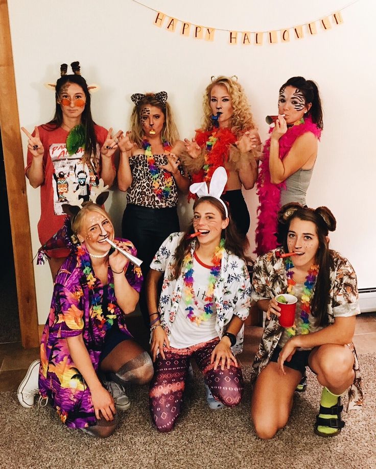 a group of women dressed in costumes posing for a photo with one woman brushing her teeth