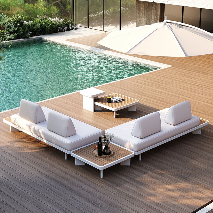 an outdoor lounge area next to a swimming pool