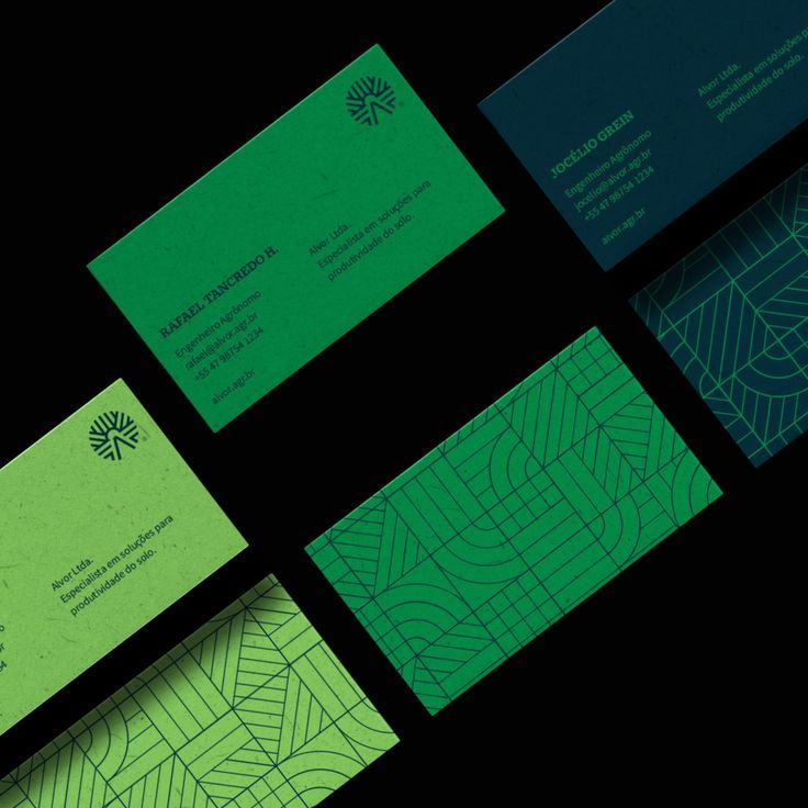 several business cards with green and blue designs on them