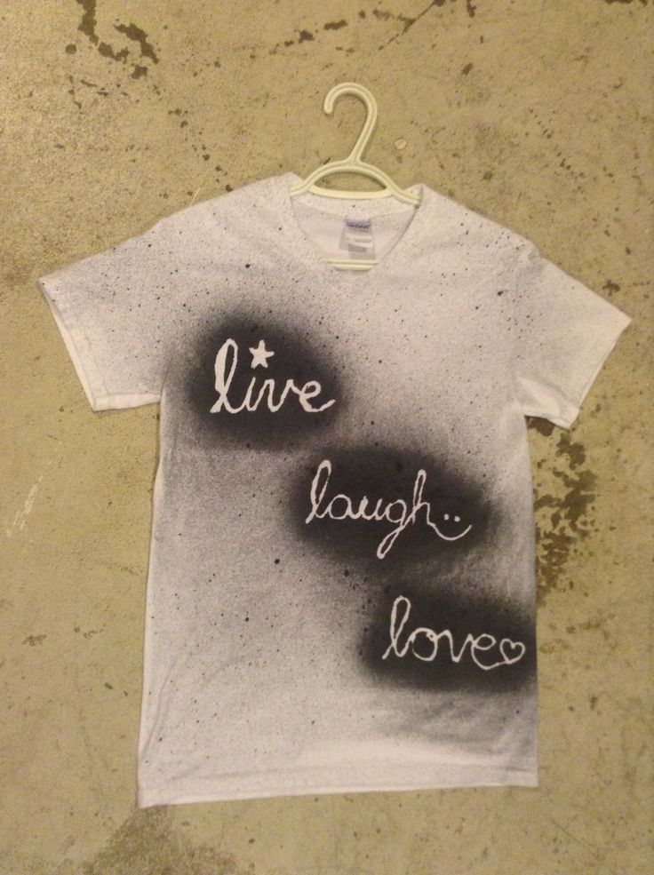 a white t - shirt with the words live laugh love written in black ink on it