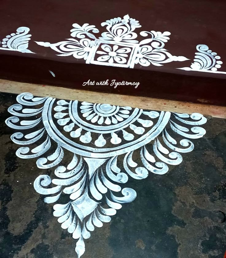 an open book sitting on top of a wooden table next to a red and white object