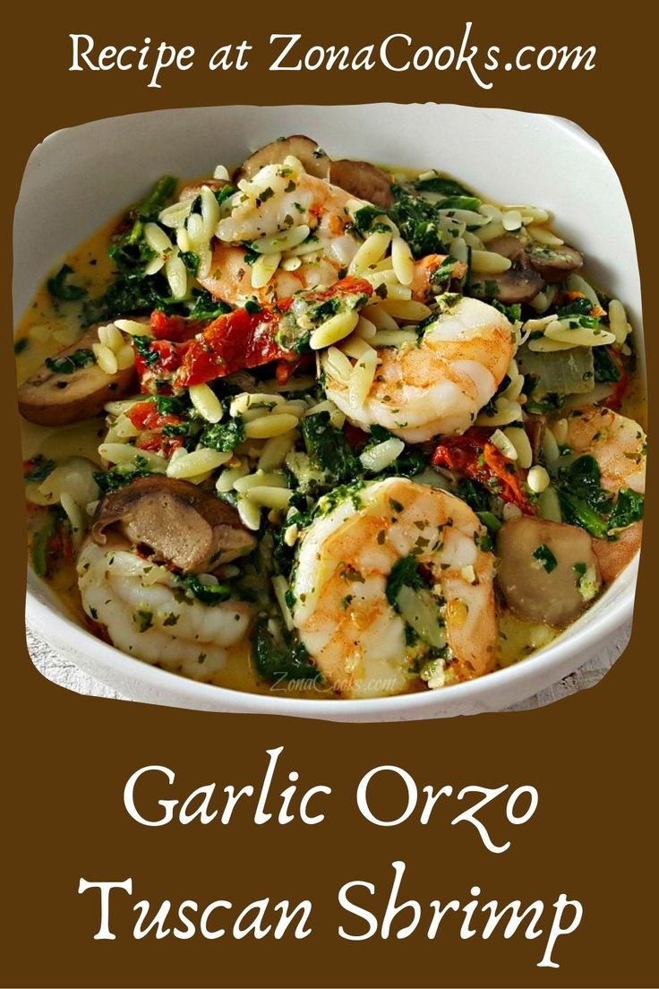 garlic orzo pasta with shrimp and spinach in a white bowl