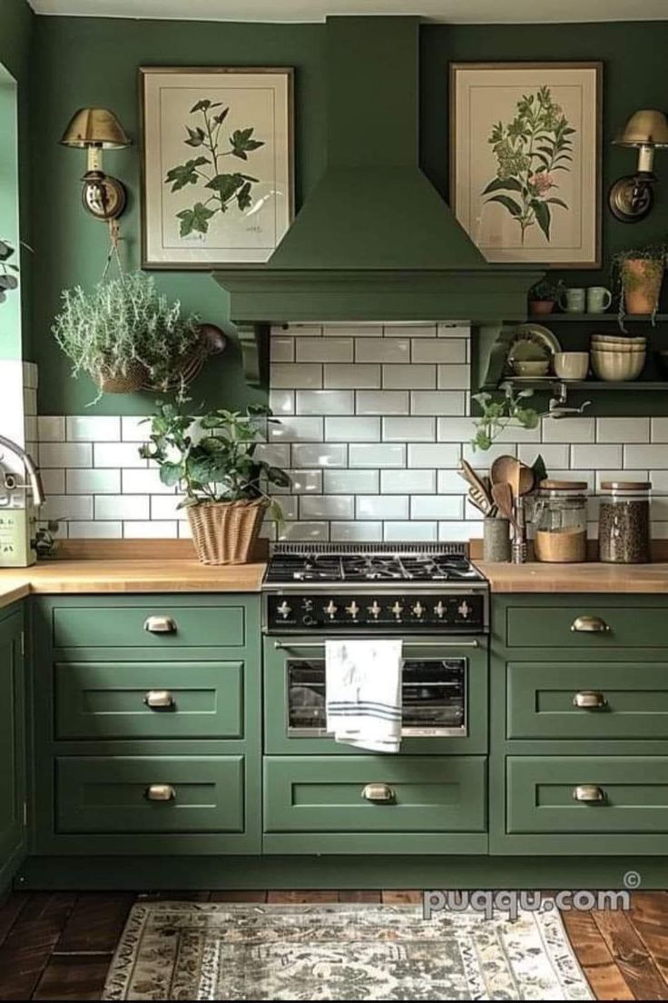 a kitchen with green cabinets and white subway tile backsplash, potted plants on the stove