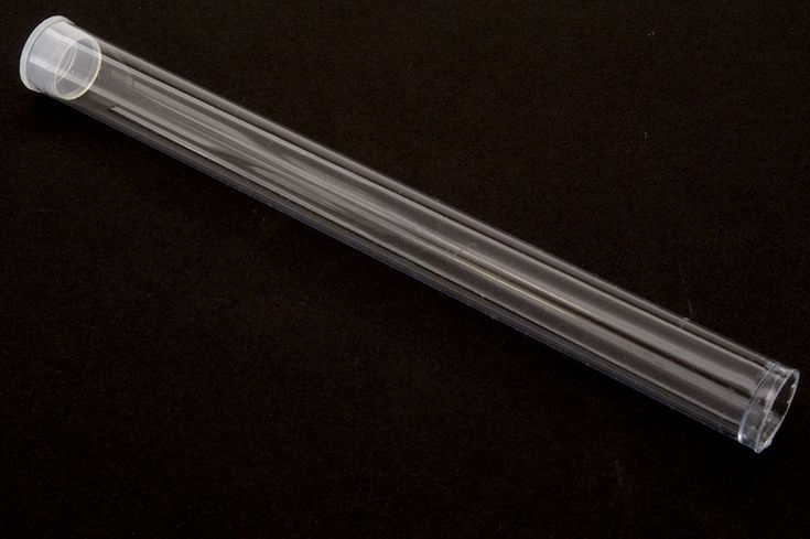 a clear plastic tube on a black surface