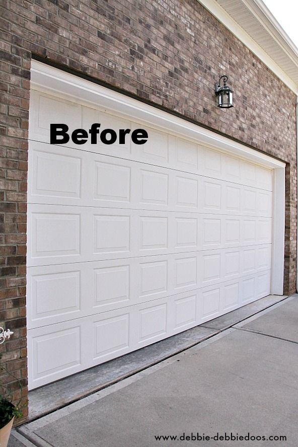 a white garage door with the words before and after written on it in front of a brick building