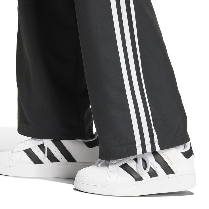 Wide legs make for comfortable days... The adidas Wide Leg Women's Cargo Pants give you plenty of room to move, along with handy cargo pockets to store your belongings. And with the iconic adidas stripes down the side, you can get the comfort and classic style the brand is known for.Features adidas three-stripe design. Relaxed fit. Elastic waistband. Features two cargo pockets. Material: 100% Polyester. Consists of at least 40% recycled materials. Contains 50% Parley Ocean Plastic. Women's Cargo Pants, Adidas Three Stripes, Adidas Tee, Back To School Backpacks, Black And White Sneakers, Move Along, Nike Tees, Cargo Pant, Cargo Pants Women