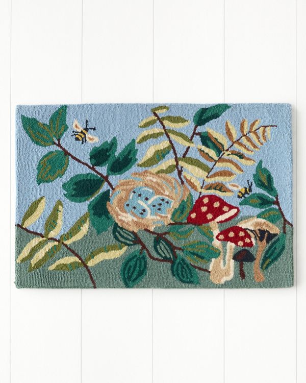 a blue rug with mushrooms and leaves on it