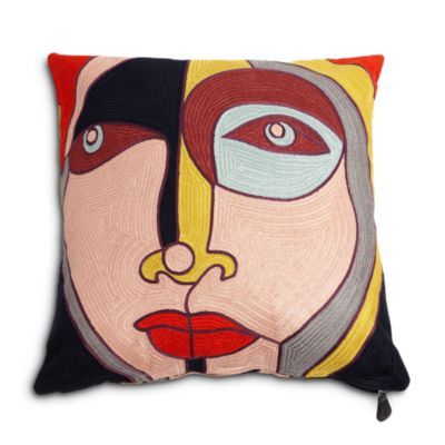 a decorative pillow with an abstract face on the front and side, featuring red lips