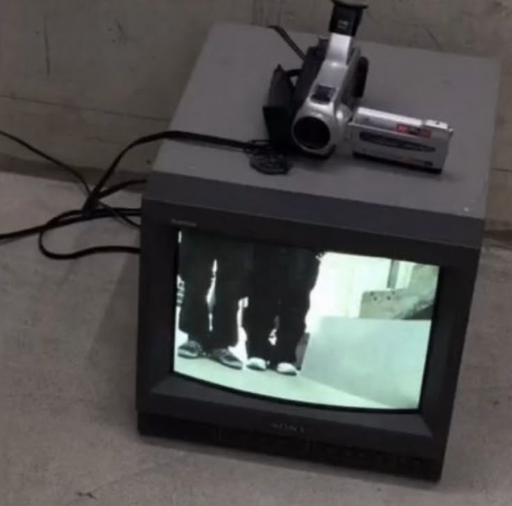 a small television with a camera on top of it