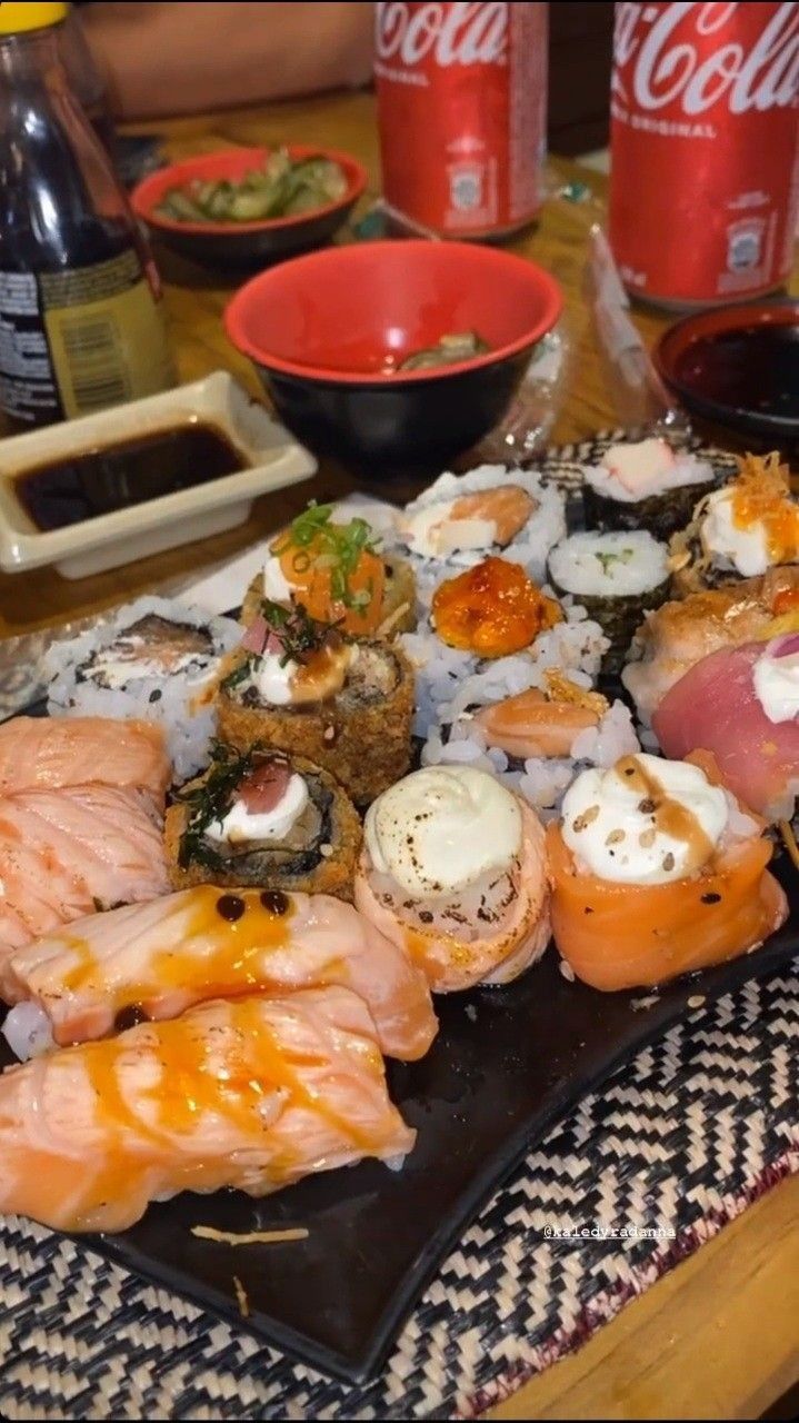 sushi platter with various types of meats and sauces on the side