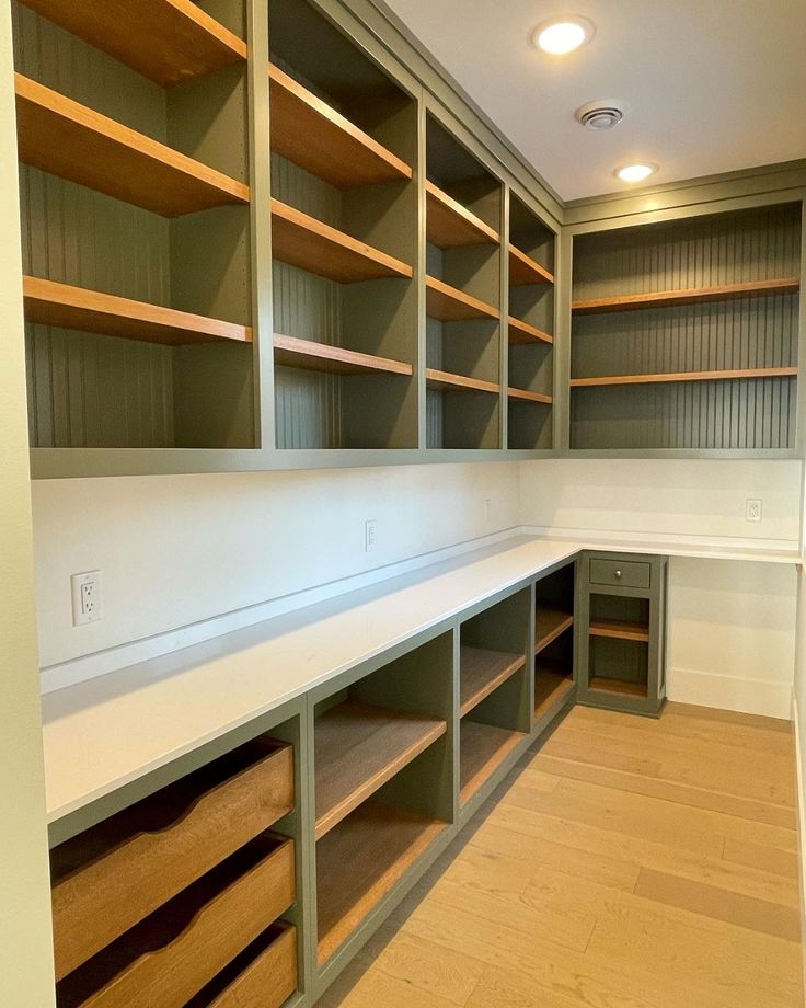 an empty walk in closet with lots of shelves