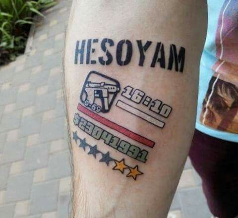 a person with a tattoo on their arm that reads hesoyam and has a bus