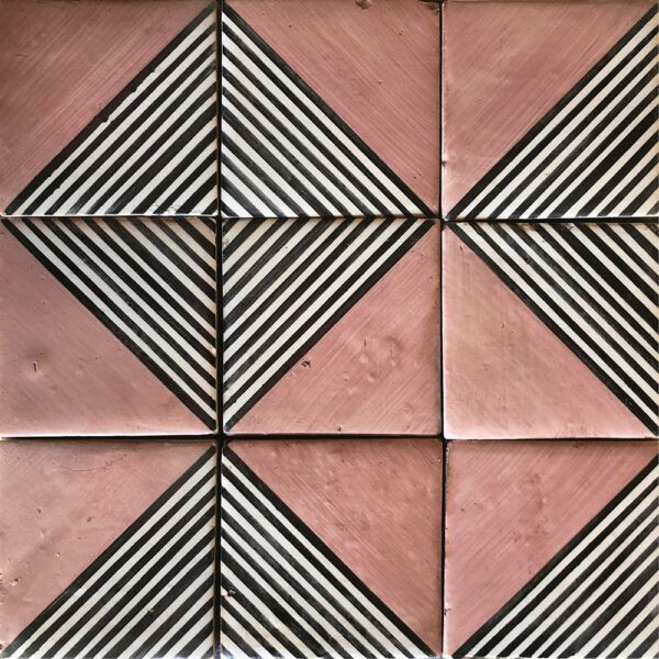 some pink and black tiles are arranged in a square pattern with diagonals on them